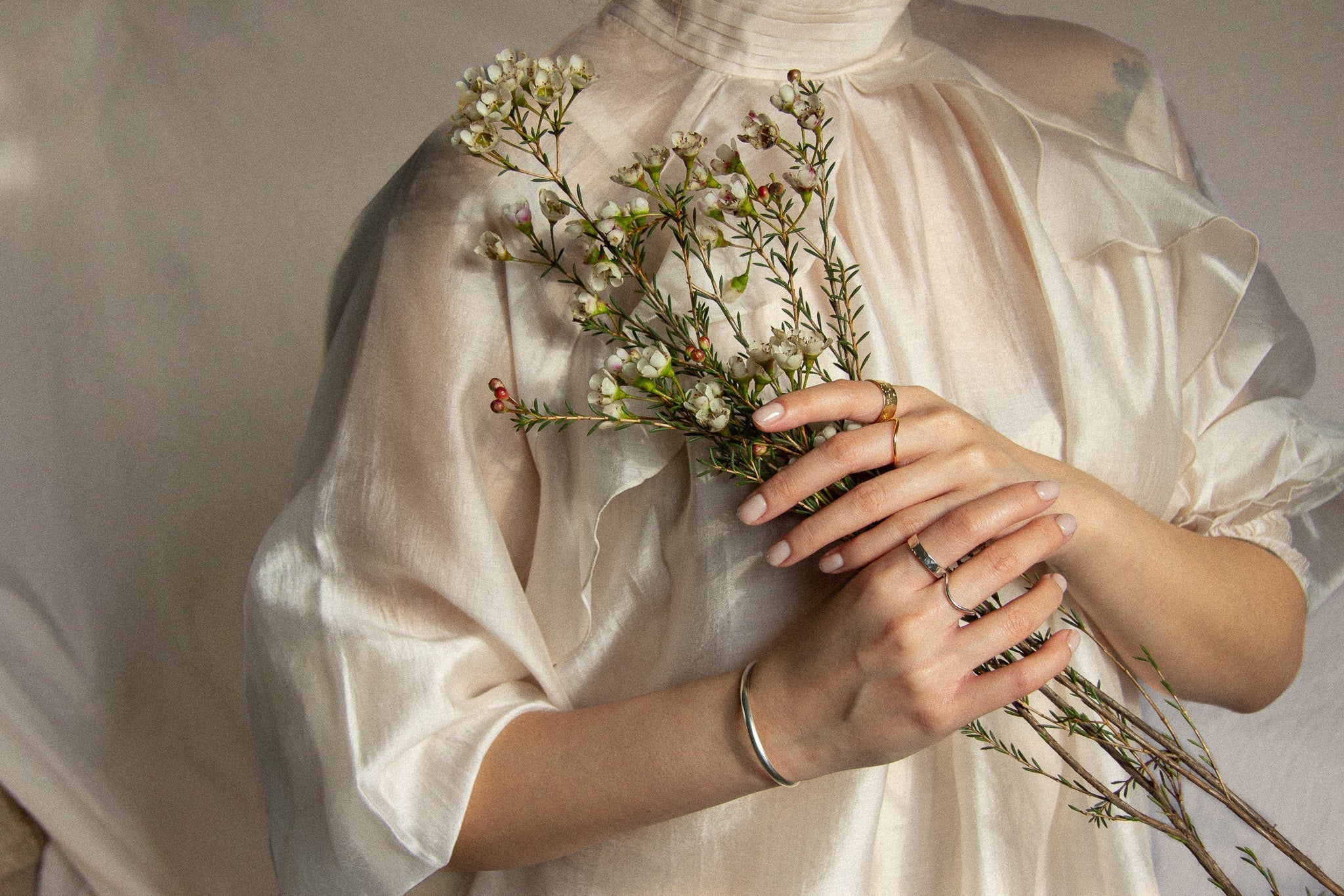 valentines day jewellery being worn by model holding flowers