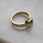 Emerald solitaire wide band engagement ring